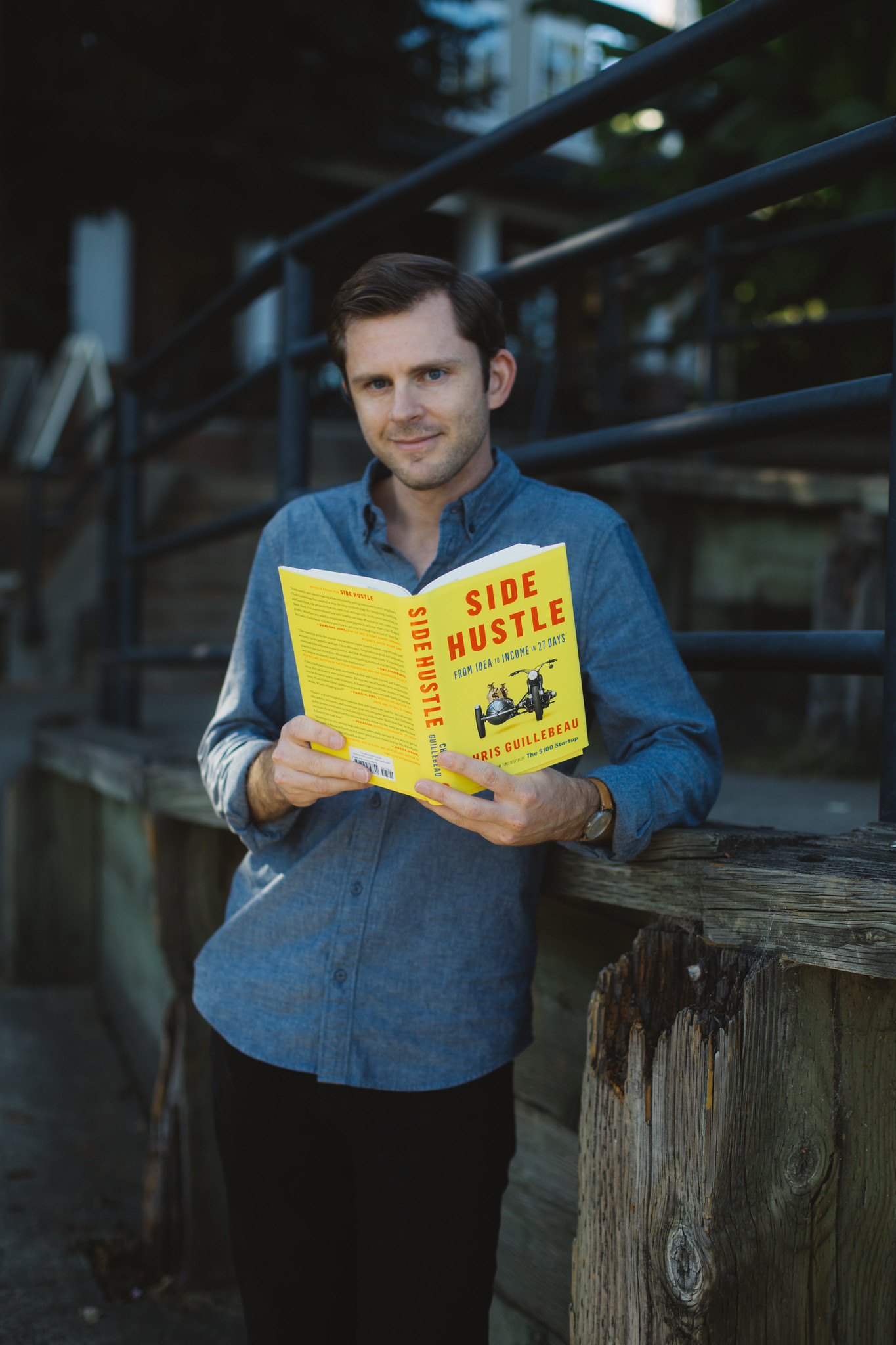 Chris Guillebeau holding the Side Hustle book