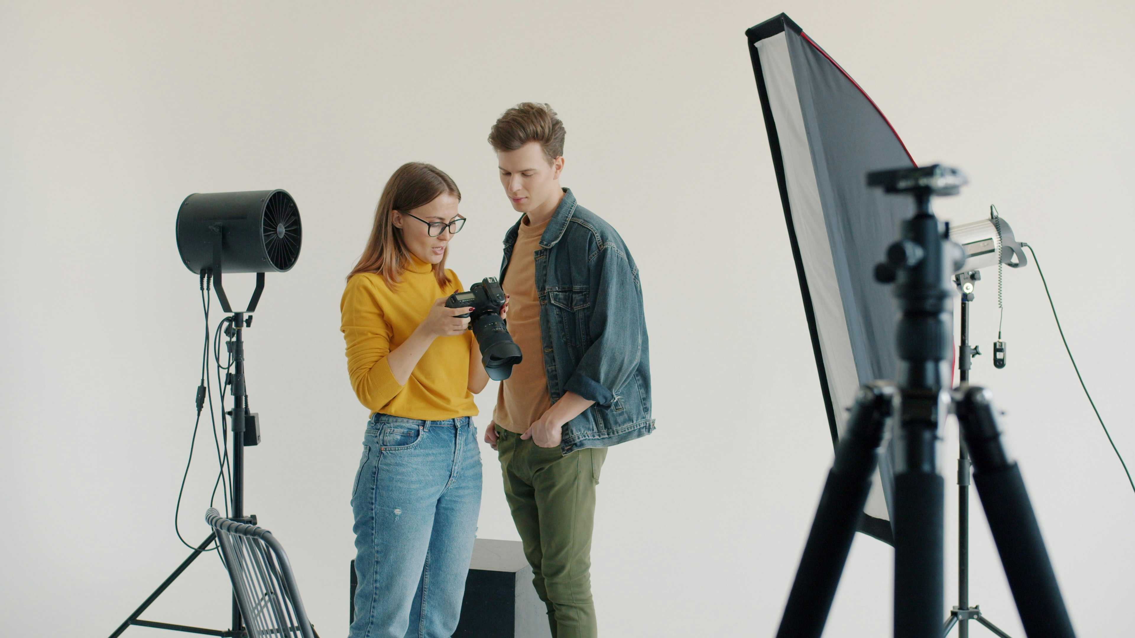 Two people reviewing an image on a camera